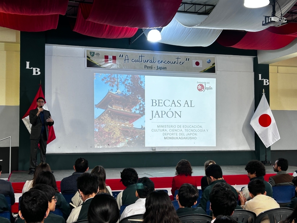 在ペルー日本大使館現地職員が、ロード・バイロン学校の生徒の前で、国費留学制度に関する説明会を行っている。