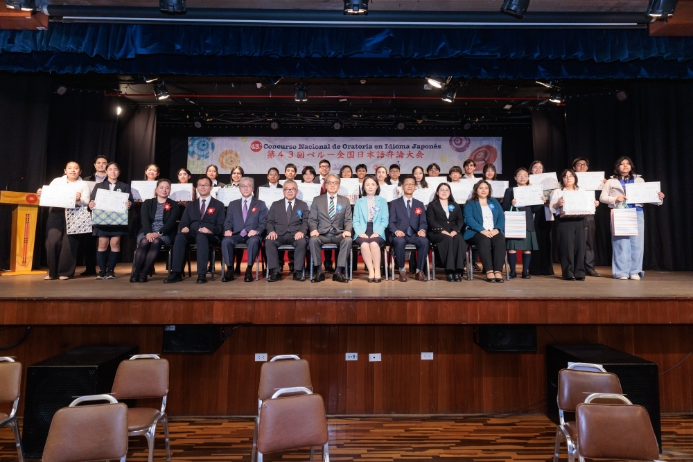 山元大使、大使夫人、審査員、ペルー日系人協会関係者が、日本語弁論大会の参加者と記念撮影を行っている。